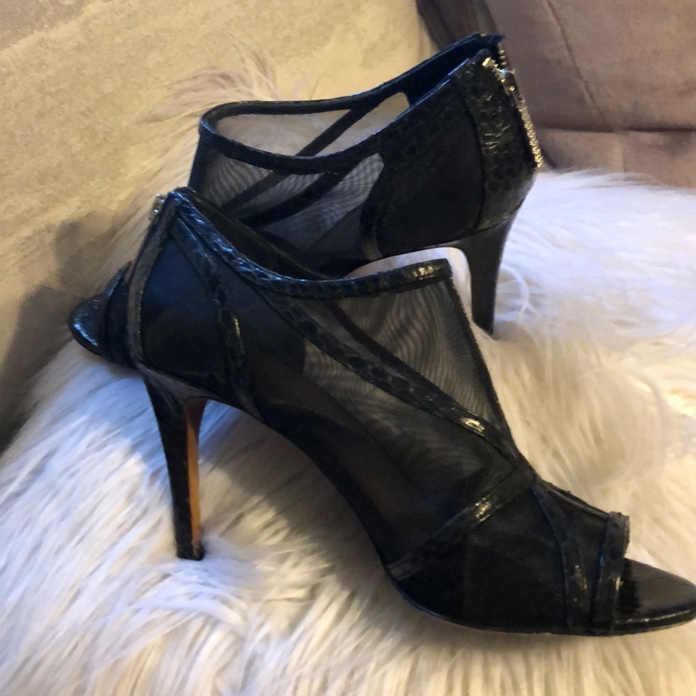 Black heels, narrow in fit. Worn